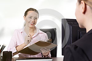 Two businesspeople working at desk in office