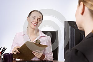 Two businesspeople working at desk in office