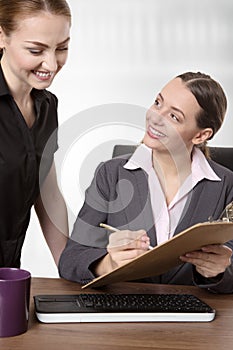 Two businesspeople working at desk in office