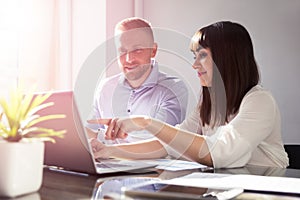 Two Businesspeople Working In Office