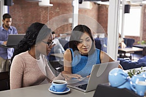 Two Businesswomen Have Informal Meeting In Office Coffee Bar