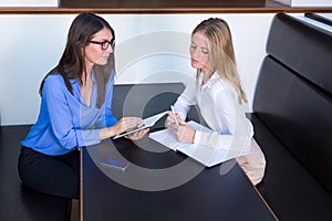 Two businesswomen having conversation