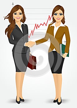 Two businesswomen shaking hands