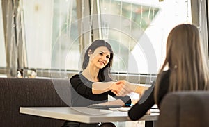 Two Businesswomen Shaking Hands