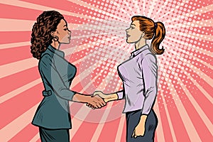 Two businesswomen shaking hands