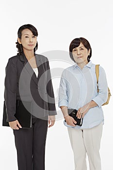 Two businesswomen smiling at the camera