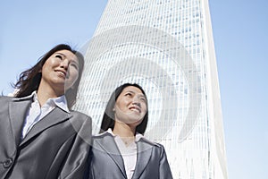 Two businesswomen standing in front of Chinas world trade center in Beijing