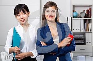 Two businesswomen standing in office