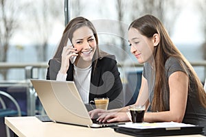 Two businesswomen working together in a bar