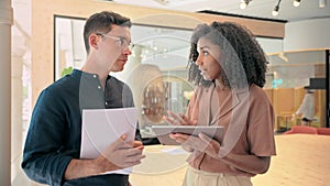 Two busy diverse professional business people working in office with document.