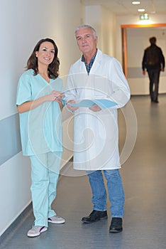 Two busy doctors on corridor