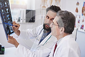 Two busy doctors discussing x-ray image