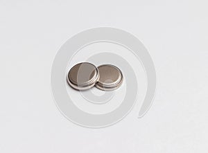 two button cell or disk cell batteries isolated on white background