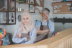 Two cafe owner standing with crossed arms