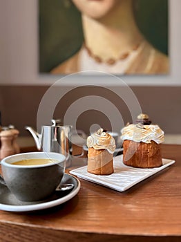Two cakes with tea on a wooden table