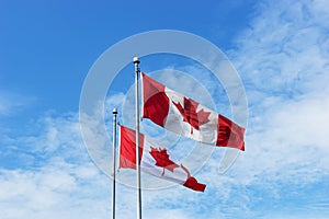Two Canadian flags in the wind