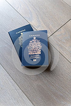 Two Canadian passports on neutral beige background