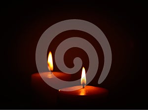 Two candle burning in dark