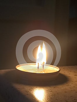 Two candles burning in the dark photo