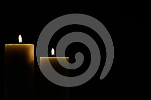 Two candles with dark background