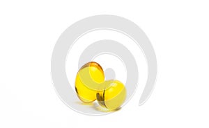 Two capsules of cod liver oil isolated on white background. Source of Omega-3 and vitamin A & D helps growth development