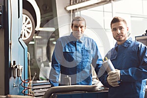 Two car experts at their workplace