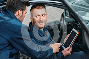 Car mechanics using digital tablet