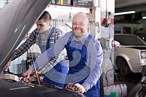Two car mechanics at workshop