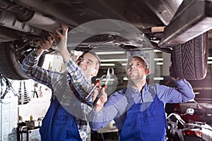 Two car mechanics at workshop