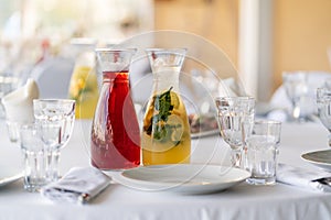 two carafes with lemonades on the table