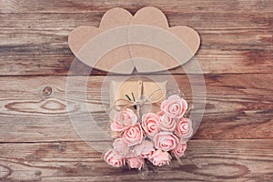 Two cardboard heart, gift box wrapped in kraft paper, bouquet of pink roses