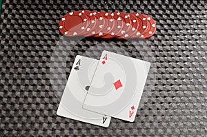 Two cards with red poker chips