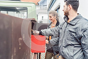 Two carpenter loading tools in mobile workshop transporter