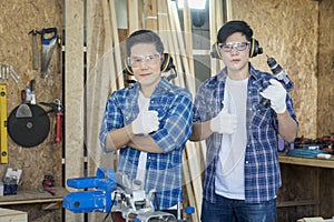 Two Carpenter showing thumb up. Young male carpenter working wood workshop