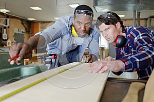 two carpenters working at workshop