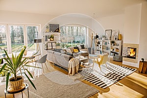 Two carpets on the floor in white Scandi living room interior wi