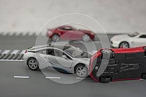 Two cars accident crash on road  insurance case, broken toys car