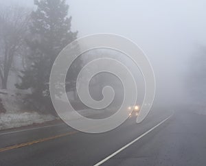 Two Cars Driving in Thick Fog