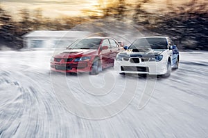 two cars fast drive race speed at winter impreza and lancer evolution