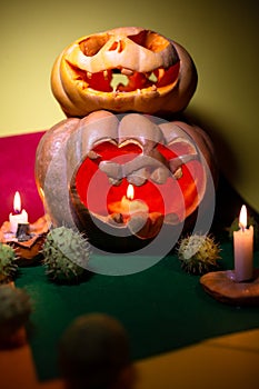 two carved pumpkins for halloween with candles