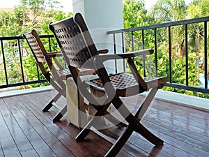 Two Carved Wooden Chairs at The Porch