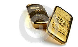 Two cast gold bars isolated on a white background.