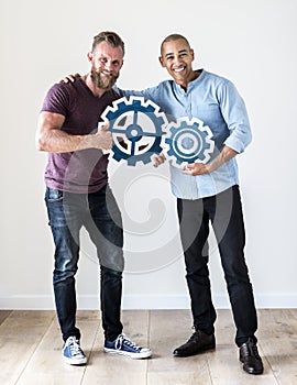 Two casual man holding cog icon