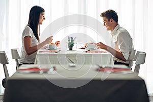 Two casual young adults having a conversation over a meal.Formal proposal,talking in a restaurant.Trying food,offers,special menu