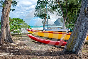 Two catamarans on the beach with the ocean and islands in the background on Waimanalo Beach, Hawaii