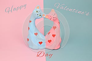 Two cats molded of clay depicted on a pink and blue background. Congratulations on Valentine's Day