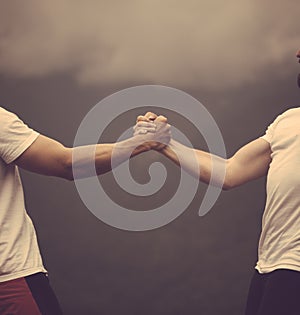 Two caucasian athletes in sportive wear measuring forces at outdoor training