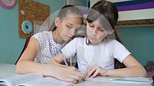 Two caucasian girls doing homework