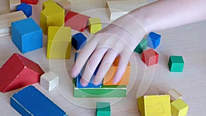 Two Caucasian kids playing together with wooden bricks