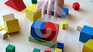 Two Caucasian kids playing together with wooden bricks